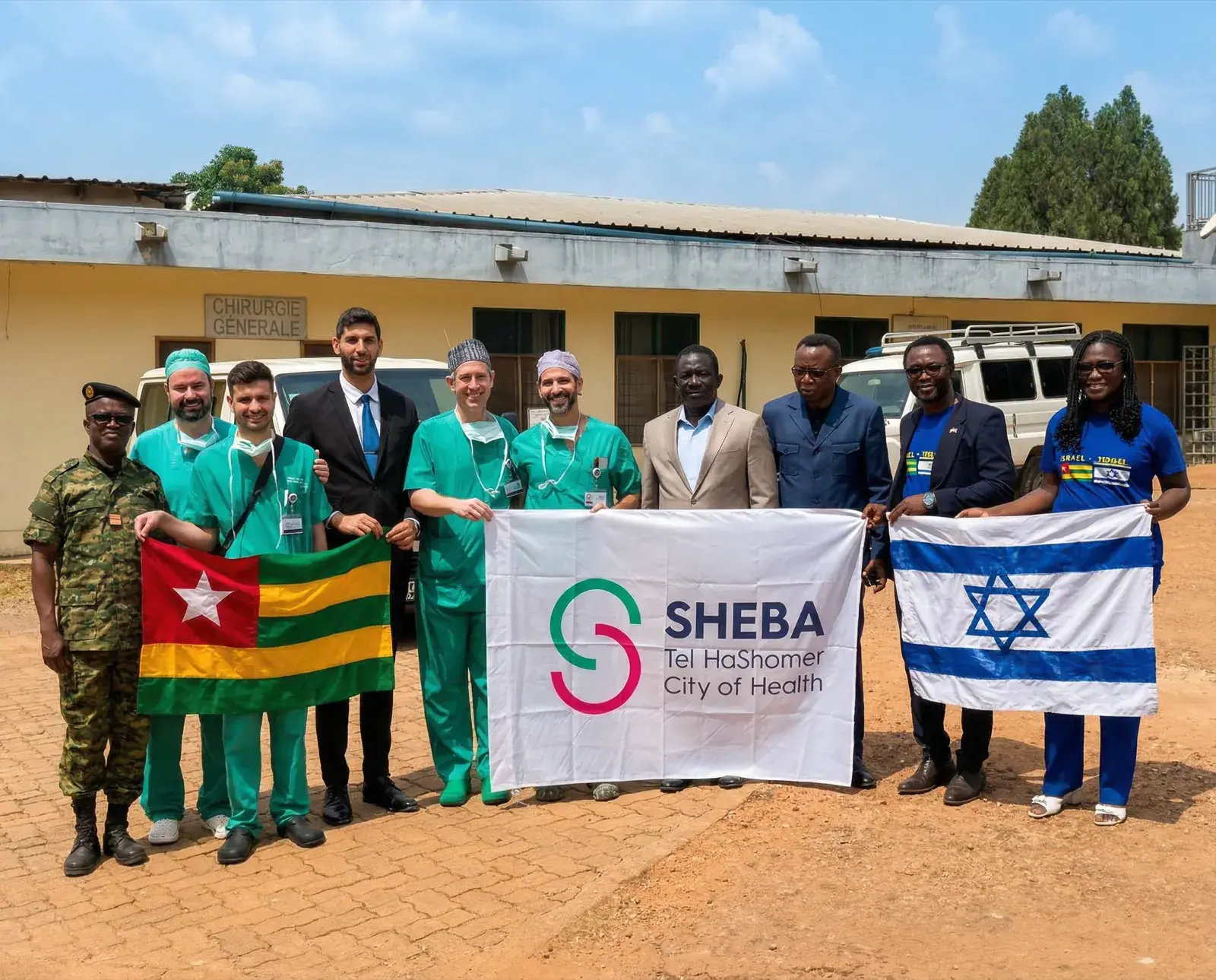 Green Medical and Sheba team with Togo and Israel flags at hospital
